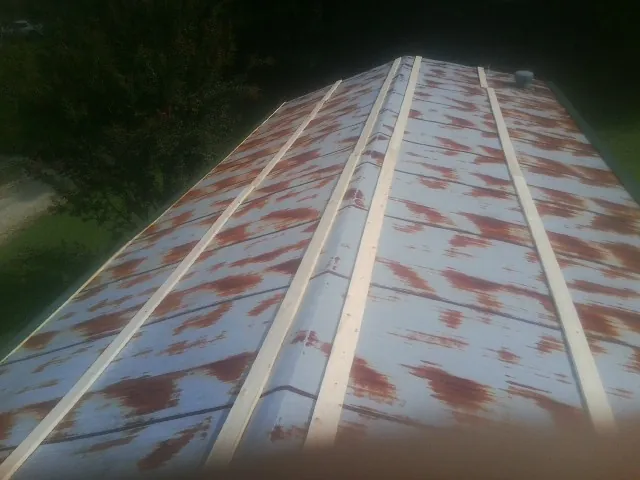 Rusted metal roof panels with new wood purlins before replacement — Storm Damage Roof Repair in Jenkintown by Roofing Brothers