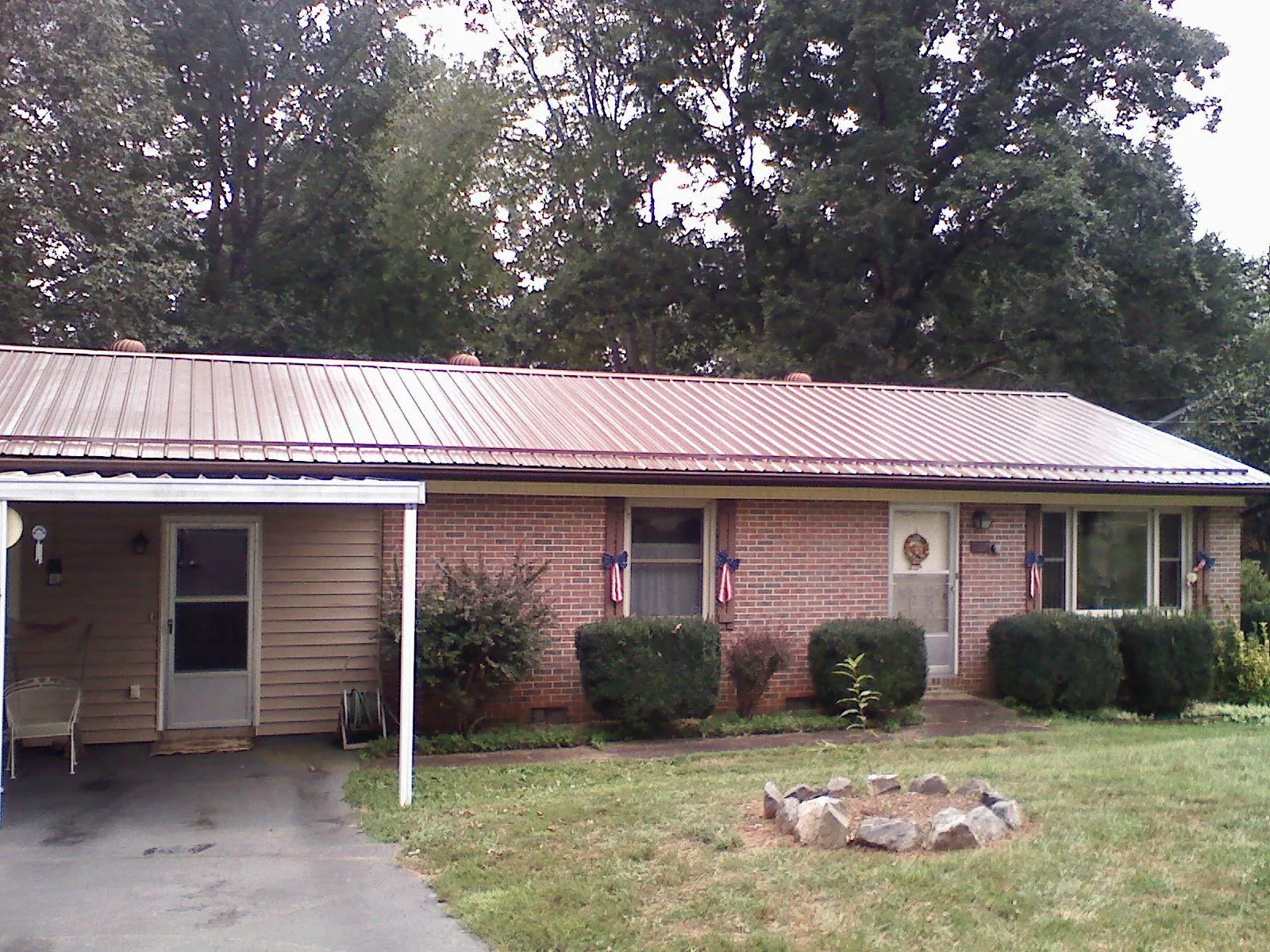 Bronze metal roof and carport on a brick ranch home — Roof Repair work by our crew in Jenkintown
